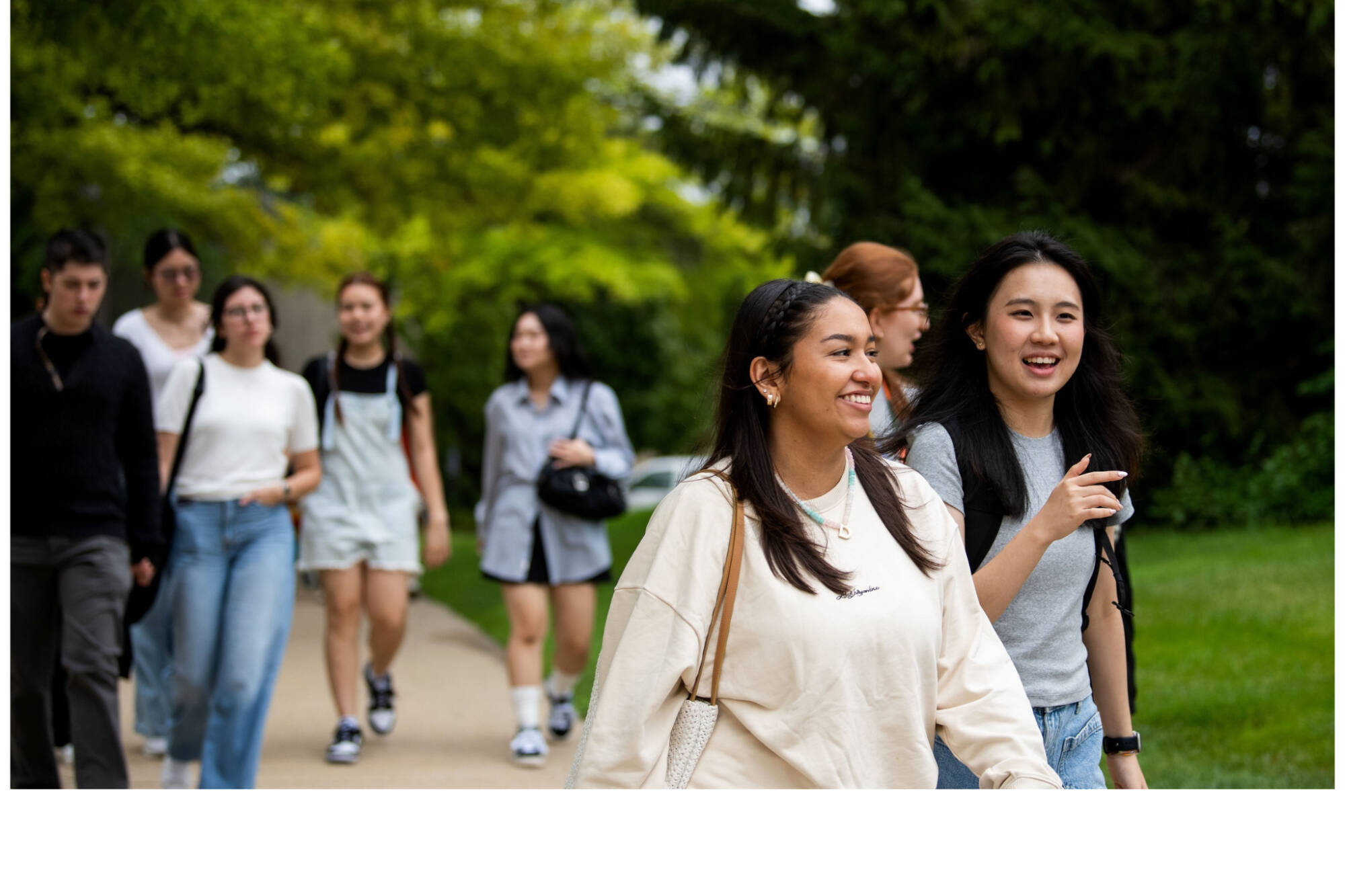students walking on campus smiling
